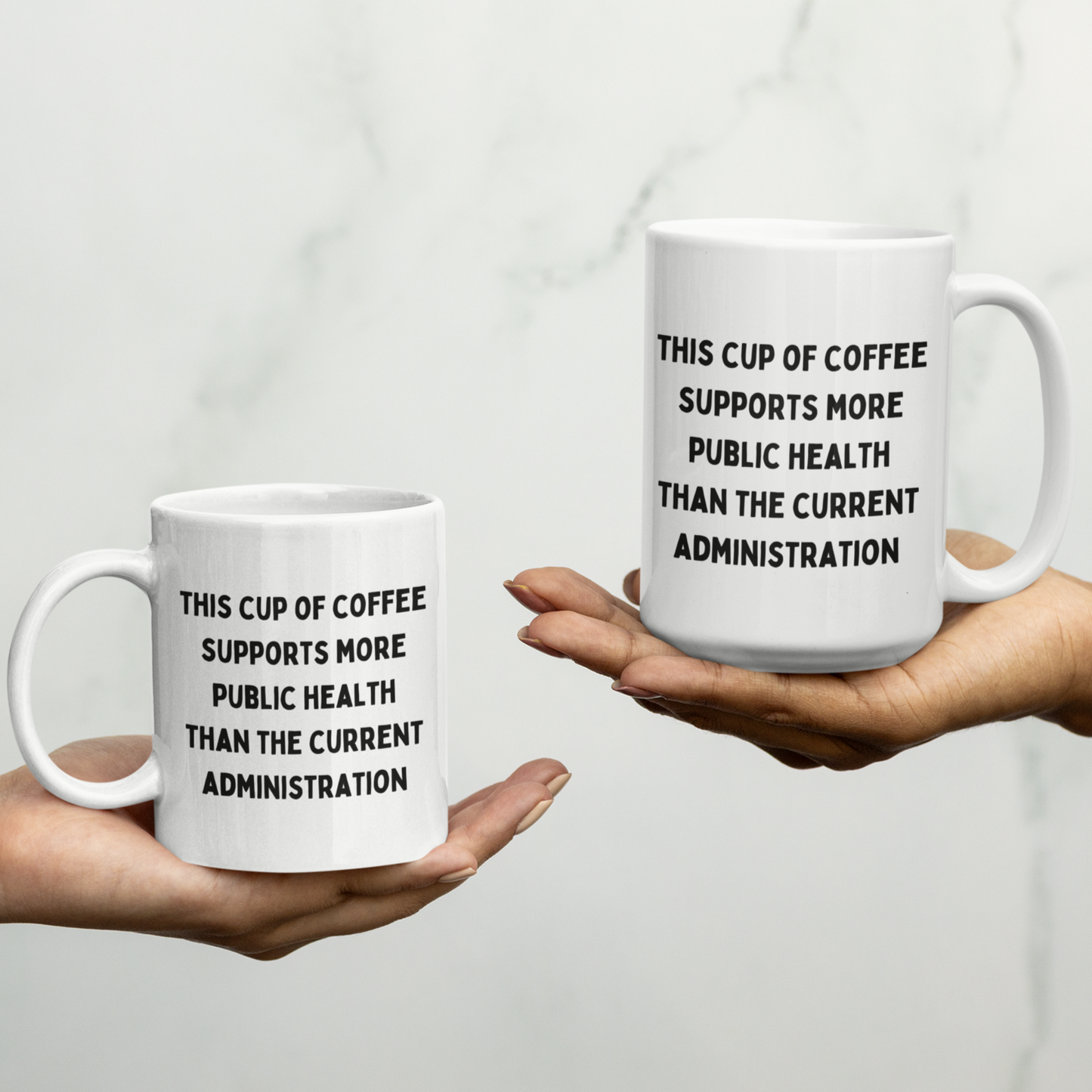 11 & 15 oz white ceramic coffee mug with handle, perfect for daily use at home or in the office. The mug features a bold, humorous political statement printed in all-caps black font: "THIS CUP OF COFFEE SUPPORTS MORE PUBLIC HEALTH THAN THE CURRENT ADMINISTRATION." The text is centered and covers most of the front surface, making it highly visible.