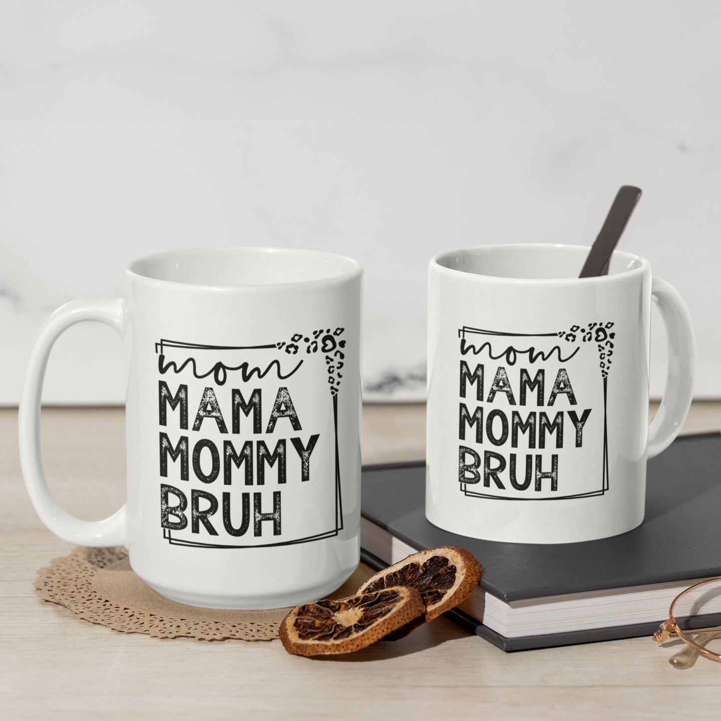 11 & 15 oz white mug displaying a playful design that reads "mom MAMA MOMMY BRUH" in black, framed with leopard print details. A funny gift for moms with a sense of humor.