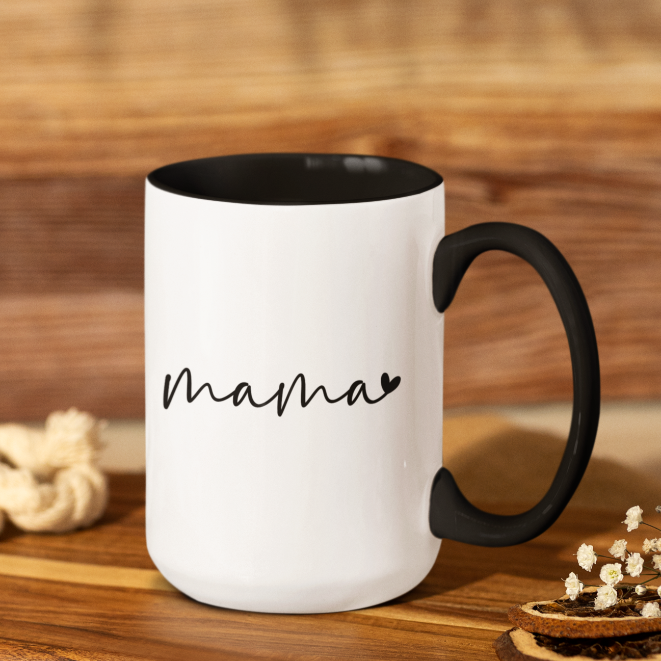 Modern 15 oz white ceramic mug with a sleek black interior and matching black handle, featuring elegant handwritten-style text that says “mama” with a small heart accent. Perfect for gifting to stylish moms who appreciate minimalistic design with a heartfelt touch — ideal for Mother’s Day, birthdays, or everyday coffee moments.