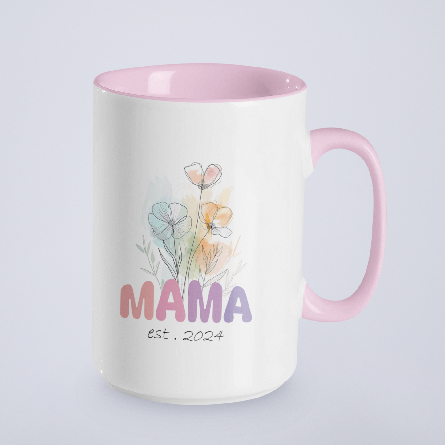 Adorable 15 oz white ceramic coffee mug with a glossy finish, featuring a soft pink interior and matching pink handle. The design showcases a delicate watercolor floral bouquet above the word “MAMA” in cheerful gradient tones from pink to purple, with the text “est. 2024” in a stylish handwritten script below. This mug is a perfect gift for new moms celebrating their first Mother's Day or a sweet keepsake marking the beginning of their motherhood journey.