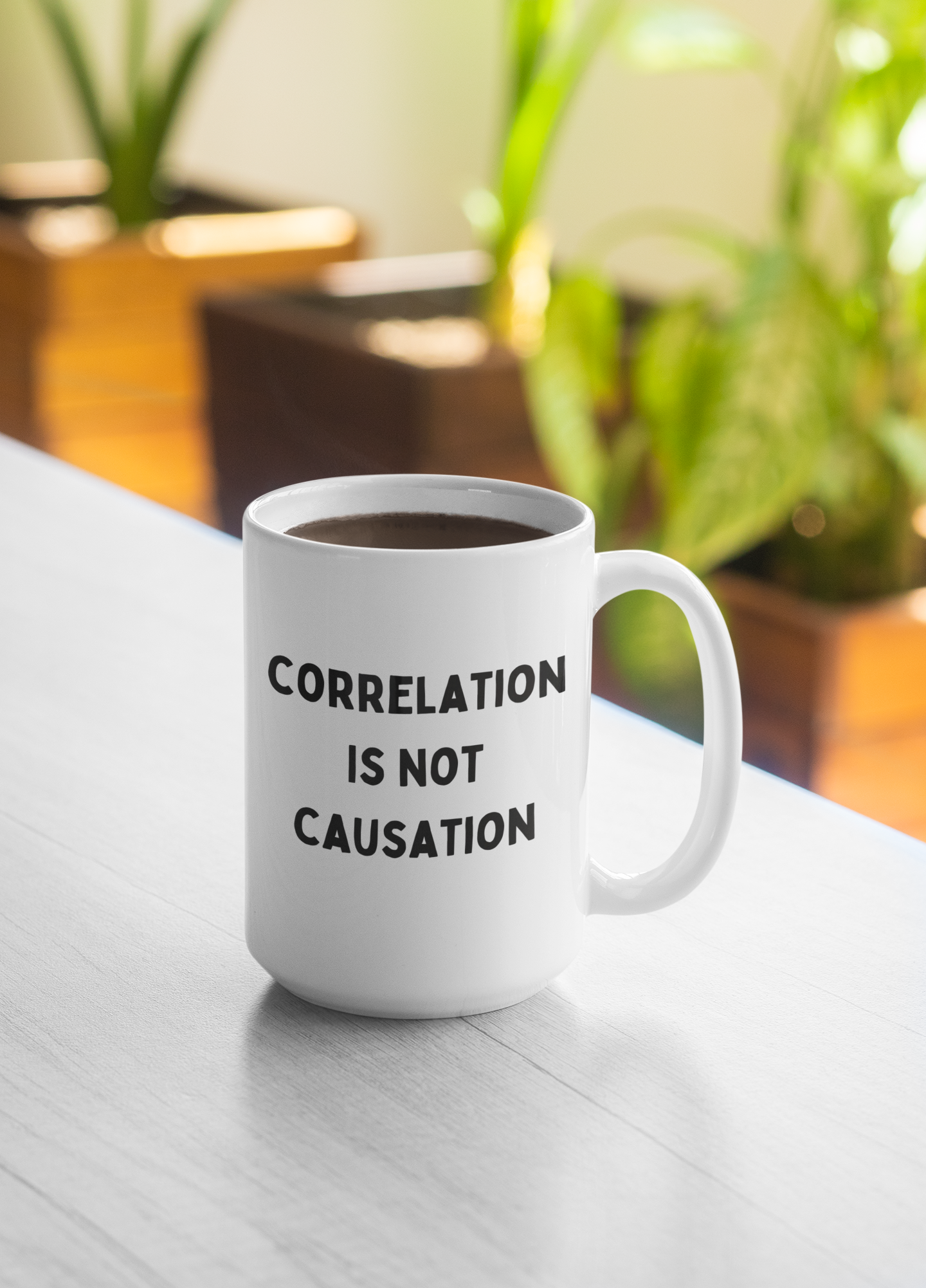15 oz white ceramic coffee mug displayed on a light surface, filled with coffee. Bold black text on the front reads "CORRELATION IS NOT CAUSATION," with an intentional typo where "CAUSATION" is spelled "CAUSATION." The sturdy handle and high-quality finish offer both comfort and durability.