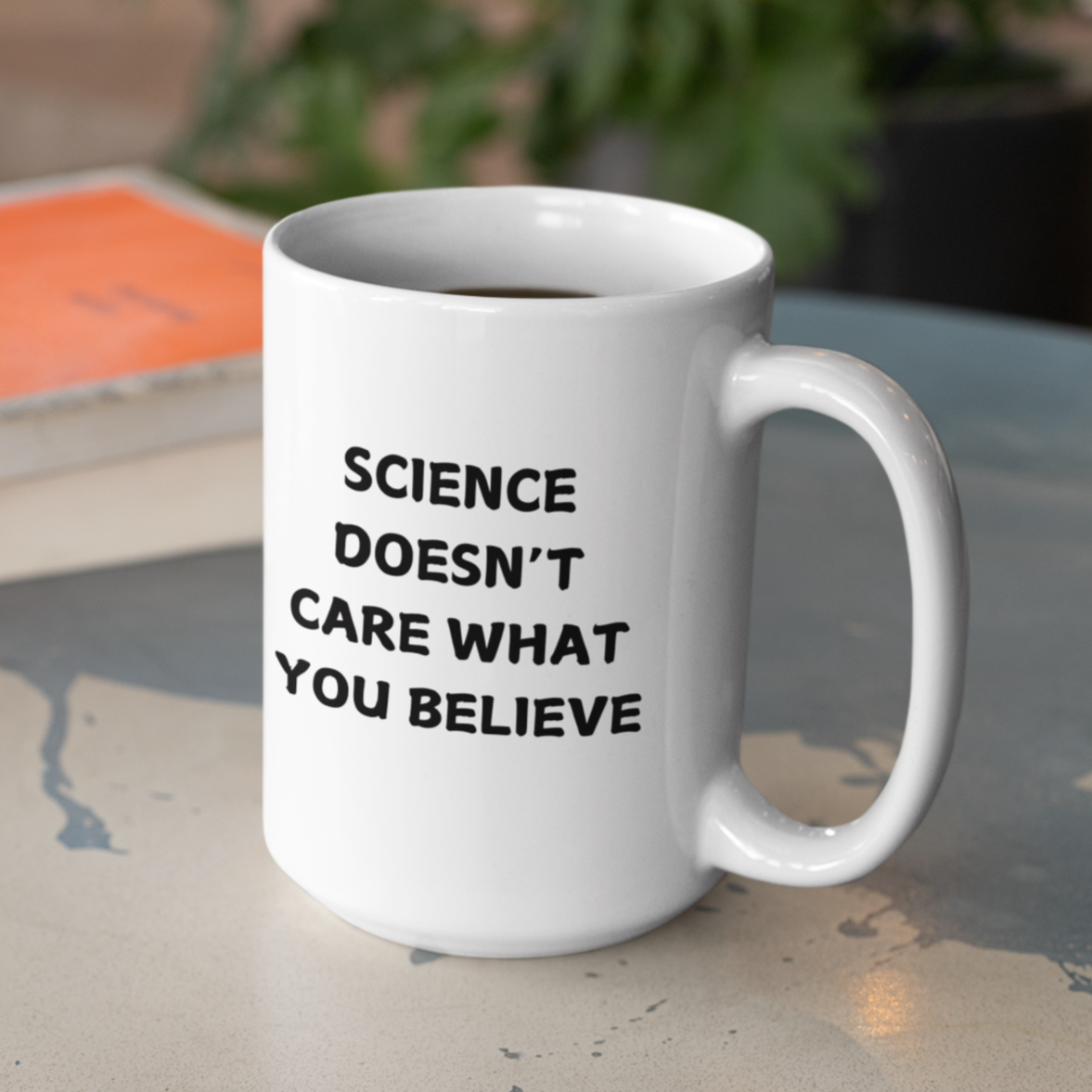 15 oz white ceramic coffee mug featuring a bold, black printed message that reads: "SCIENCE DOESN'T CARE WHAT YOU BELIEVE." The text is centered on the front of the mug, making it easy to read while holding it. The mug has a smooth glossy finish, a comfortable C-shaped handle, and a durable design perfect for everyday use. Ideal for science enthusiasts, skeptics, and anyone who appreciates evidence-based thinking.