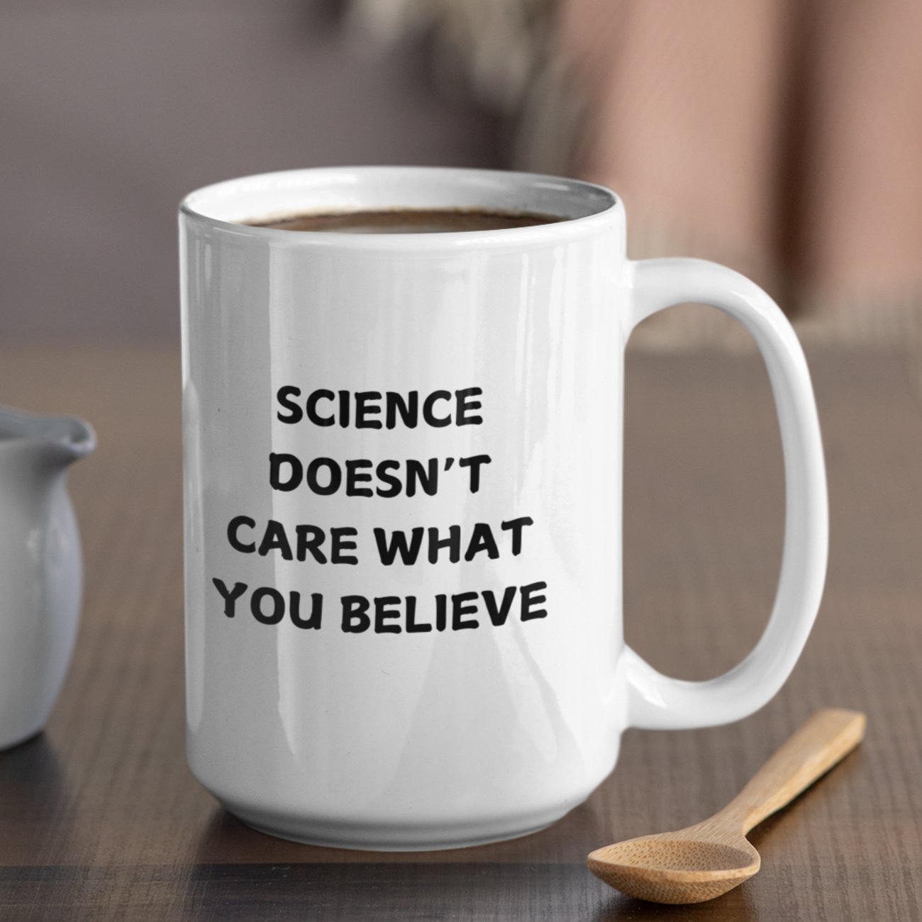 15 oz white ceramic coffee mug featuring a bold, black printed message that reads: "SCIENCE DOESN'T CARE WHAT YOU BELIEVE." The text is centered on the front of the mug, making it easy to read while holding it. The mug has a smooth glossy finish, a comfortable C-shaped handle, and a durable design perfect for everyday use. Ideal for science enthusiasts, skeptics, and anyone who appreciates evidence-based thinking.