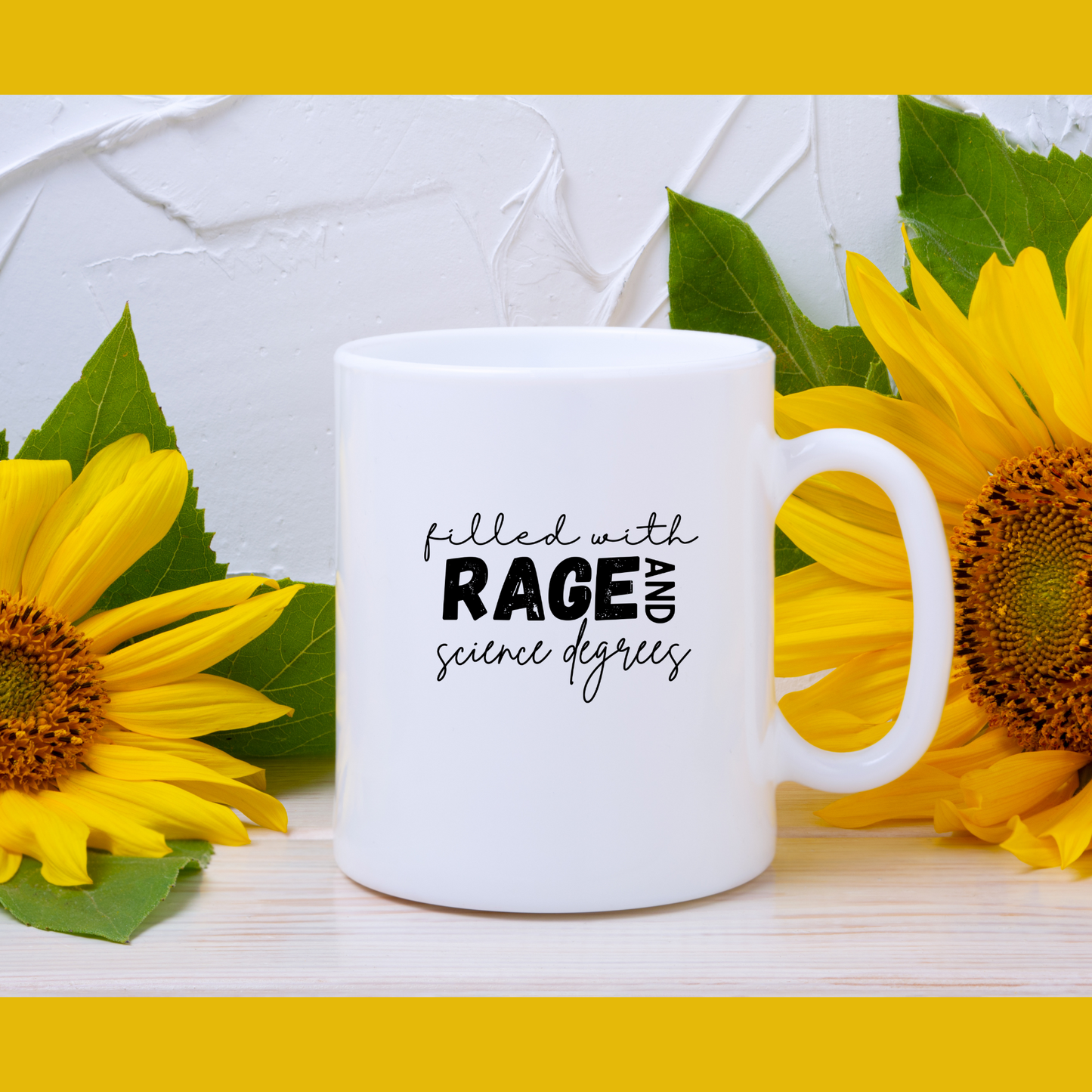 11 oz Close-up of a white ceramic coffee mug that features a bold and playful typography design that reads: "filled with RAGE AND science degrees." The words "RAGE AND" are in bold, uppercase letters, while the rest of the text is in a casual, handwritten script. Ideal for scientists, academics, or STEM enthusiasts.