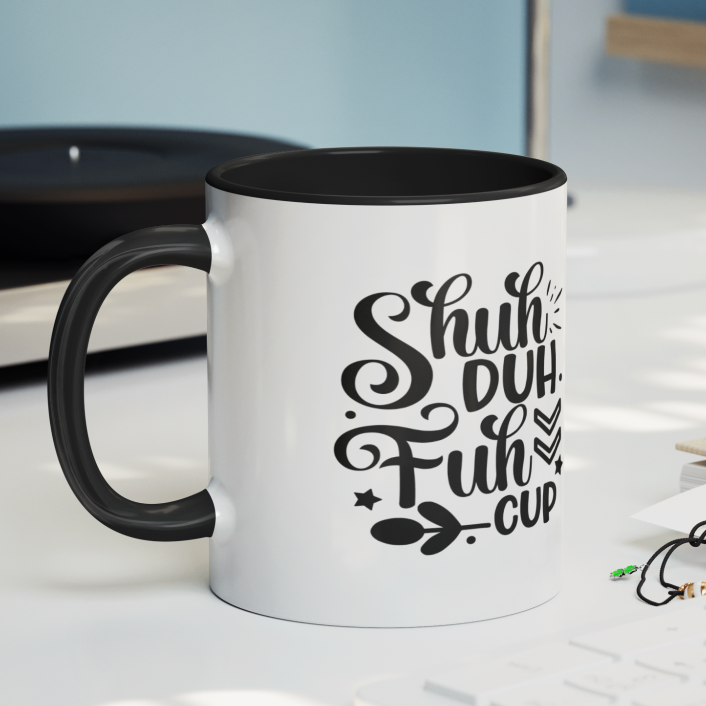 Bold and cheeky white ceramic mug with a black handle and rim, featuring the humorous phrase “Shuh Duh Fuh Cup” in a playful black script with decorative arrows, stars, and leaves. This mug is perfect for coffee lovers with a sarcastic sense of humor. Durable, dishwasher and microwave safe—ideal for gifting or enjoying your morning brew with a side of sass.