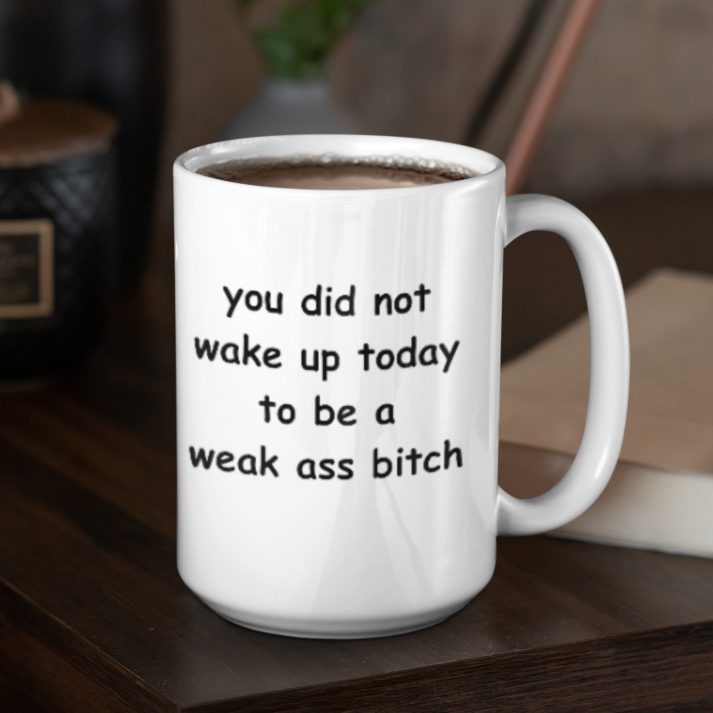White 15 oz ceramic coffee mug with a motivational and bold message printed in playful, rounded black font. The text reads: “You did not wake up today to be a weak ass bitch.” Designed to inspire confidence and a no-nonsense attitude, this mug is perfect for anyone who loves starting their day with a strong dose of motivation and humor. The glossy finish gives it a clean, polished look, while the sturdy handle ensures a comfortable grip. Ideal for coffee, tea, or gifting to badass friends!