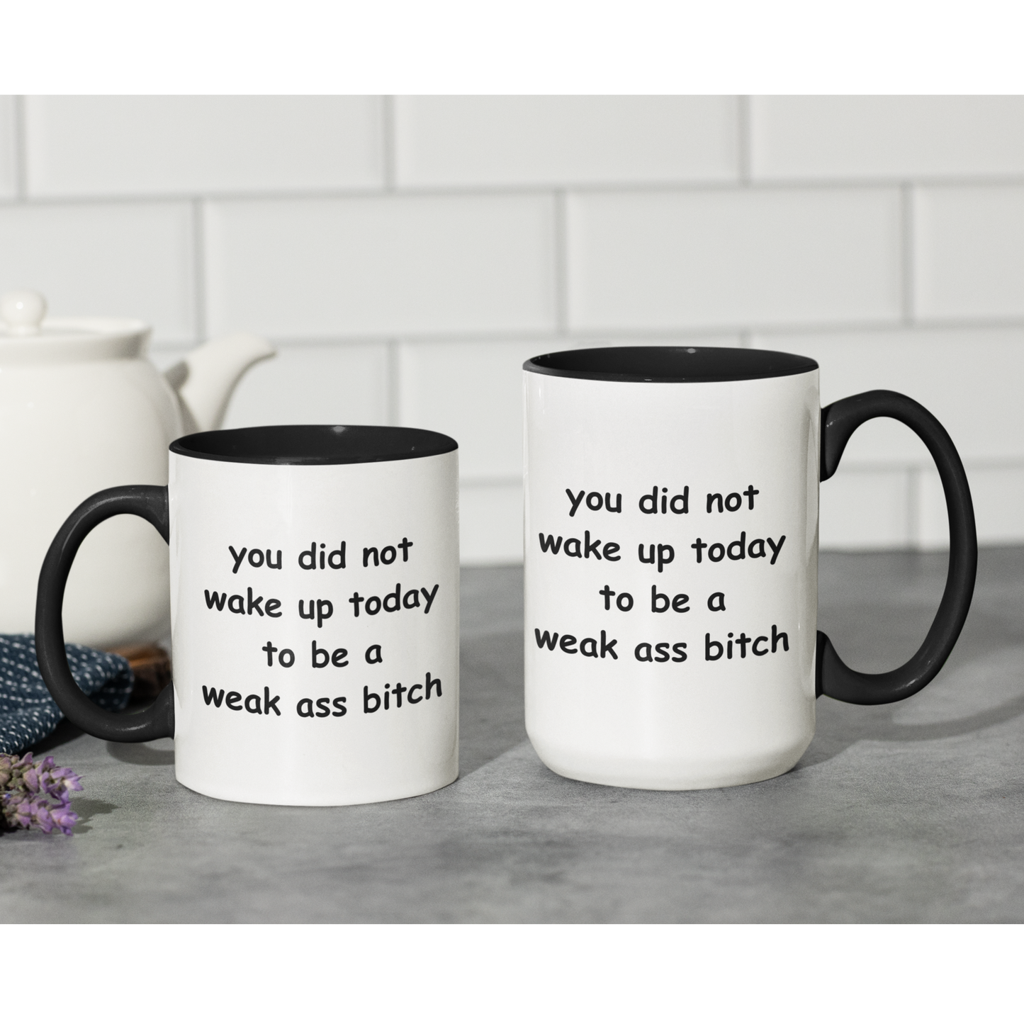 Stylish 11 & 15 oz two-tone ceramic coffee mug featuring a bold motivational message printed in playful black text. The phrase reads, “you did not wake up today to be a weak ass bitch,” inspiring confidence and a go-getter mindset with every sip. The mug has a sleek black handle and interior, contrasting sharply with the glossy white exterior for a modern look. Perfect for morning coffee, tea, or as a fun, empowering gift for friends who love a little sass with their caffeine fix.