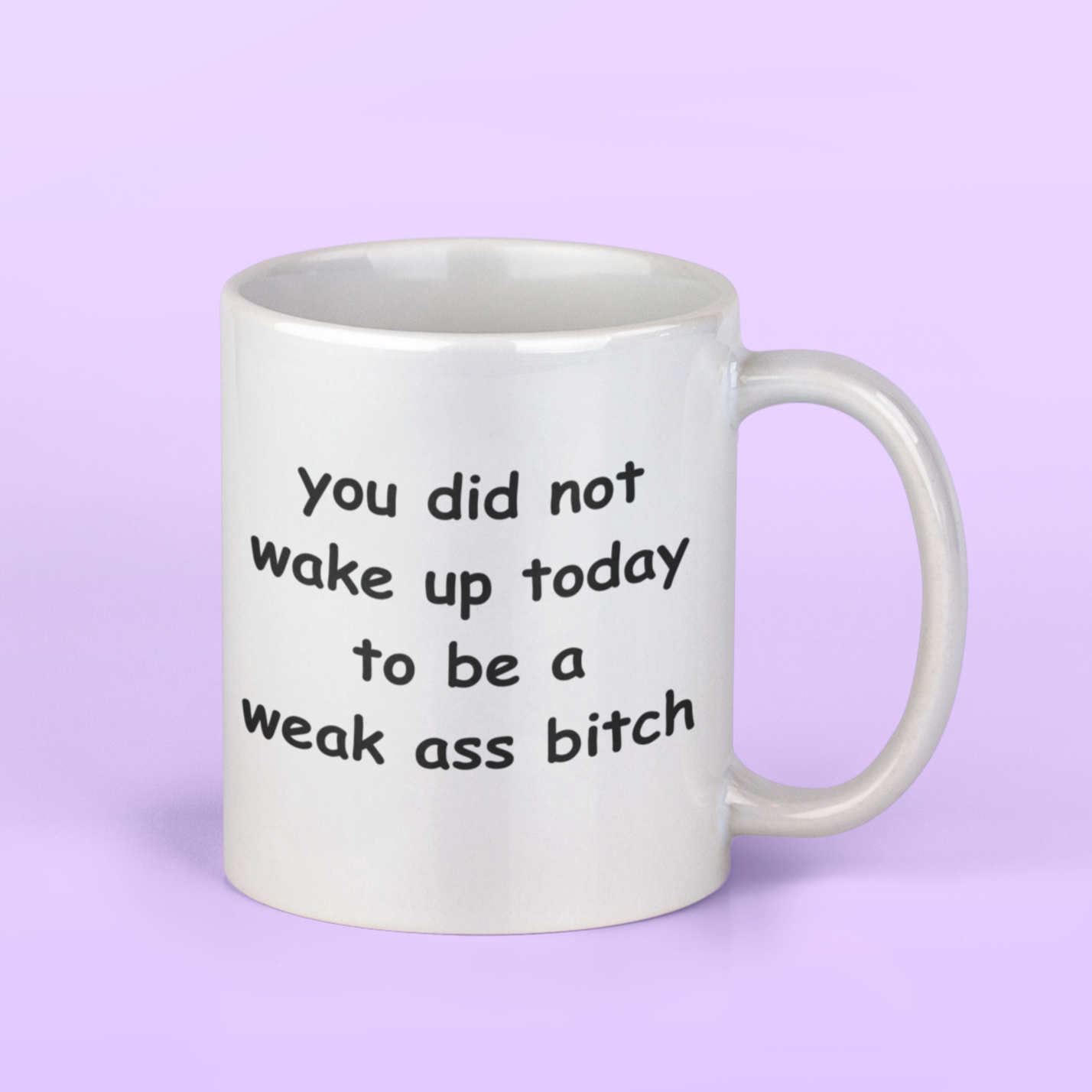 White 11 oz ceramic coffee mug with a motivational and bold message printed in playful, rounded black font. The text reads: “You did not wake up today to be a weak ass bitch.” Designed to inspire confidence and a no-nonsense attitude, this mug is perfect for anyone who loves starting their day with a strong dose of motivation and humor. The glossy finish gives it a clean, polished look, while the sturdy handle ensures a comfortable grip. Ideal for coffee, tea, or gifting to badass friends!