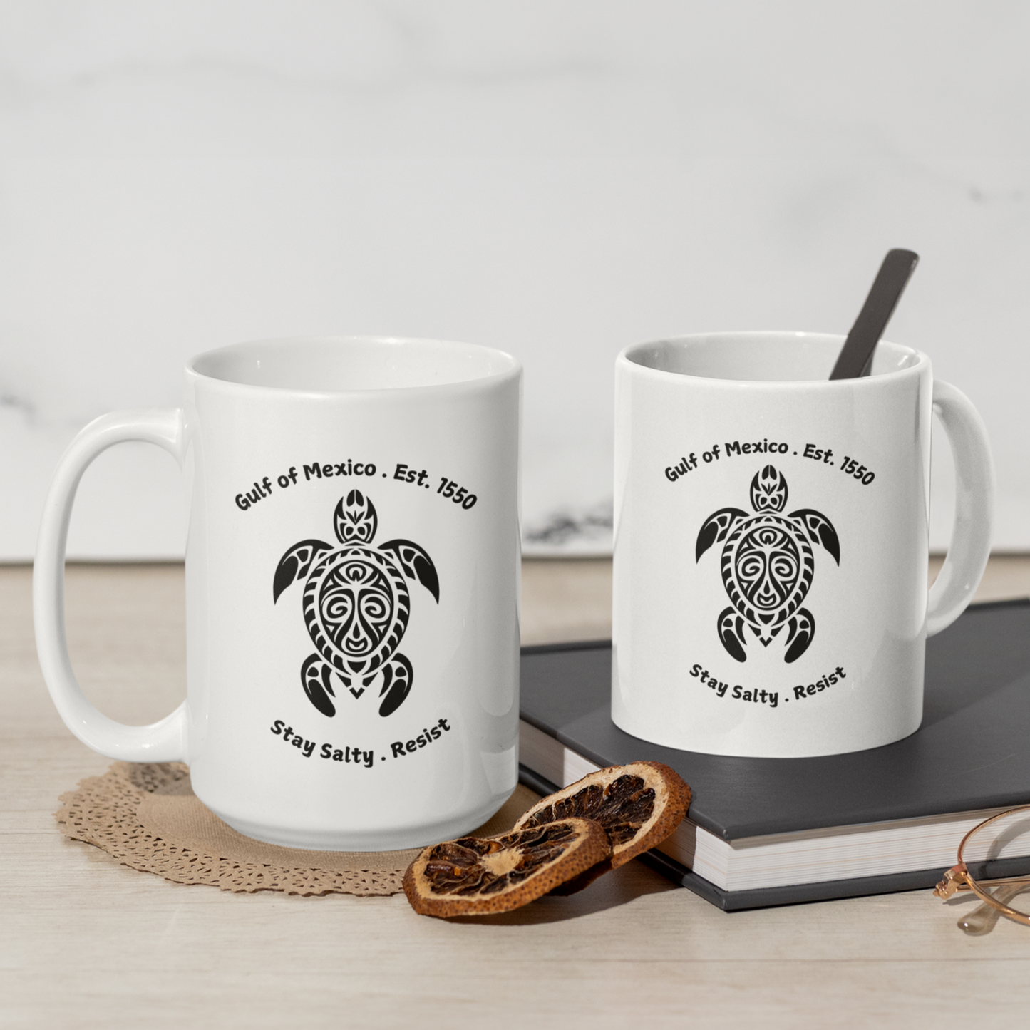 11 and 15 oz High-quality ceramic coffee mug featuring a bold, tribal-style sea turtle graphic in black. The design showcases the text “Gulf of Mexico • Est. 1550” above the turtle and “Stay Salty • Resist” below, giving it a coastal, eco-conscious vibe. The mug is finished in a glossy white glaze with a comfortable, large curved handle for easy grip. Ideal for ocean lovers, environmental advocates, or anyone who appreciates unique, artistic drinkware with a message of resilience and coastal pride.