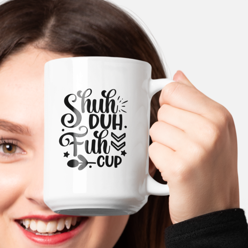 White ceramic coffee mug featuring a bold and cheeky black design that reads, “Shuh Duh Fuh Cup” in a playful script and block font mix, with whimsical accents like arrows, stars, and leaves. Perfect for anyone with a sarcastic sense of humor, this mug makes a great gift or daily dose of sass for coffee lovers. Durable, microwave and dishwasher safe.