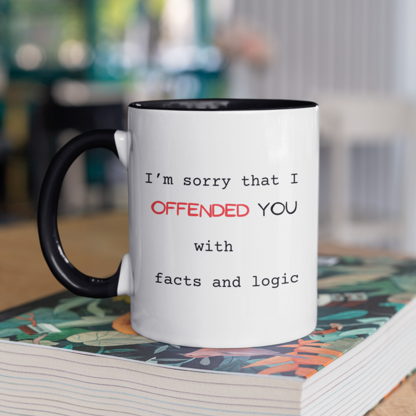 11 oz High-quality ceramic coffee mug featuring a sleek black handle and black interior for a modern, stylish look. The white exterior displays a bold, witty message in mixed fonts: "I’m sorry that I OFFENDED YOU with facts and logic." The word "OFFENDED" is highlighted in bright red uppercase text for emphasis, while the rest of the text is in a clean black typewriter font. Perfect novelty gift for coworkers, friends, or anyone who appreciates humor and sharp wit. Ideal for home or office use.
