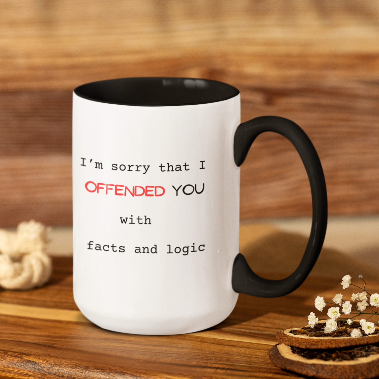 15 oz High-quality ceramic coffee mug featuring a sleek black handle and lack interior for a modern, stylish look. The white exterior displays a bold, witty message in mixed fonts: "I’m sorry that I OFFENDED YOU with facts and logic." The word "OFFENDED" is highlighted in bright red uppercase text for emphasis, while the rest of the text is in a clean black typewriter font. Perfect novelty gift for coworkers, friends, or anyone who appreciates humor and sharp wit. Ideal for home or office use.