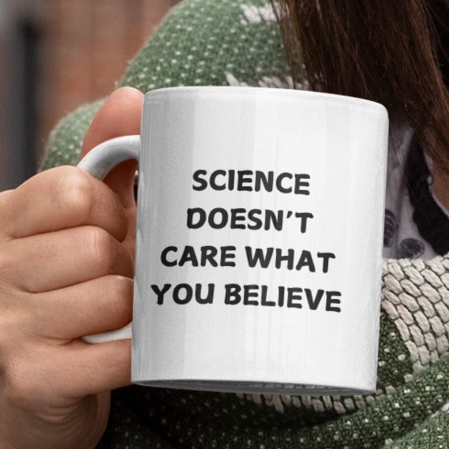 11 oz white ceramic coffee mug featuring a bold, black printed message that reads: "SCIENCE DOESN'T CARE WHAT YOU BELIEVE." The text is centered on the front of the mug, making it easy to read while holding it. The mug has a smooth glossy finish, a comfortable C-shaped handle, and a durable design perfect for everyday use. Ideal for science enthusiasts, skeptics, and anyone who appreciates evidence-based thinking.