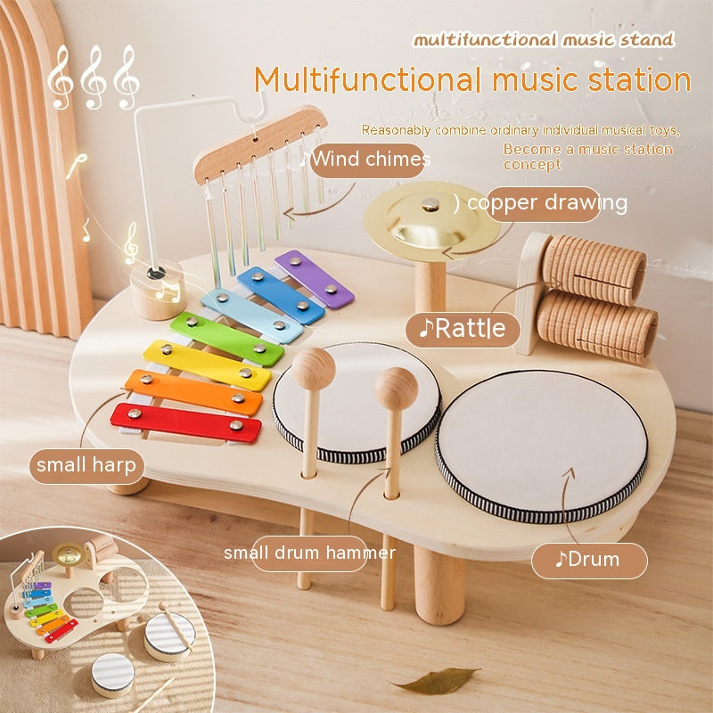 Multifunctional music station pictured with wind chimes, xylophone, rattle, cymbal, drums and drumsticks. Small inset photo shows that drums can be removed for separate use