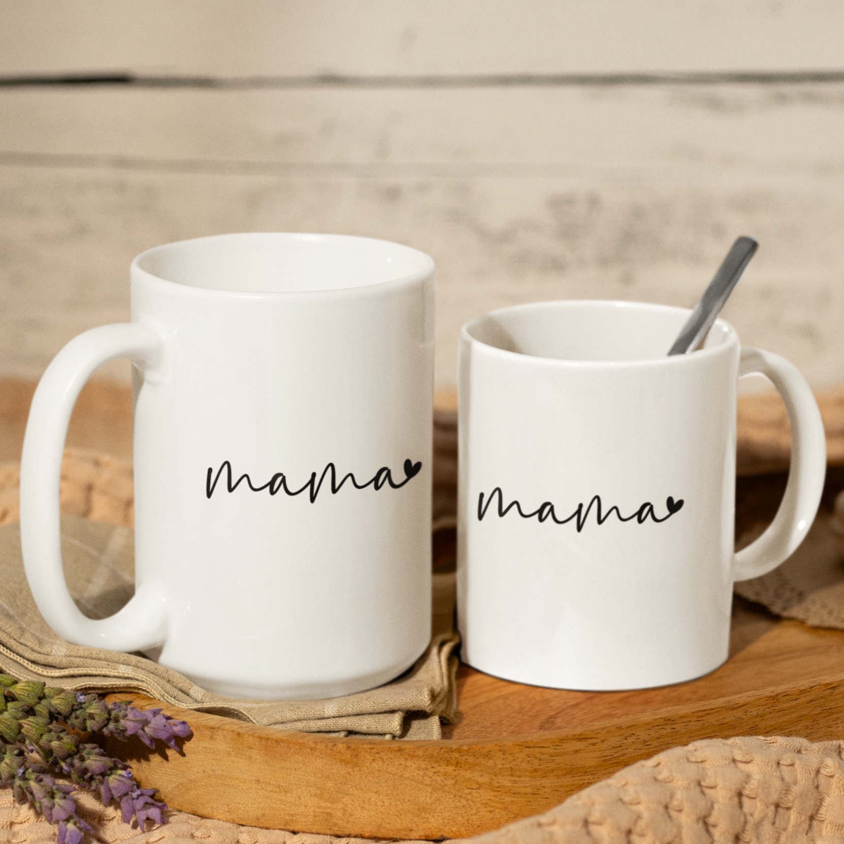 Sleek 11 & 15 oz white ceramic coffee mug featuring a minimalist black handwritten-style script that reads “mama” with a small heart accent at the end. The mug has a smooth, glossy finish and a large, easy-grip handle. Perfect for gifting to moms who appreciate simple, modern design and a daily reminder of their cherished role. Ideal for Mother’s Day, birthdays, or everyday appreciation.