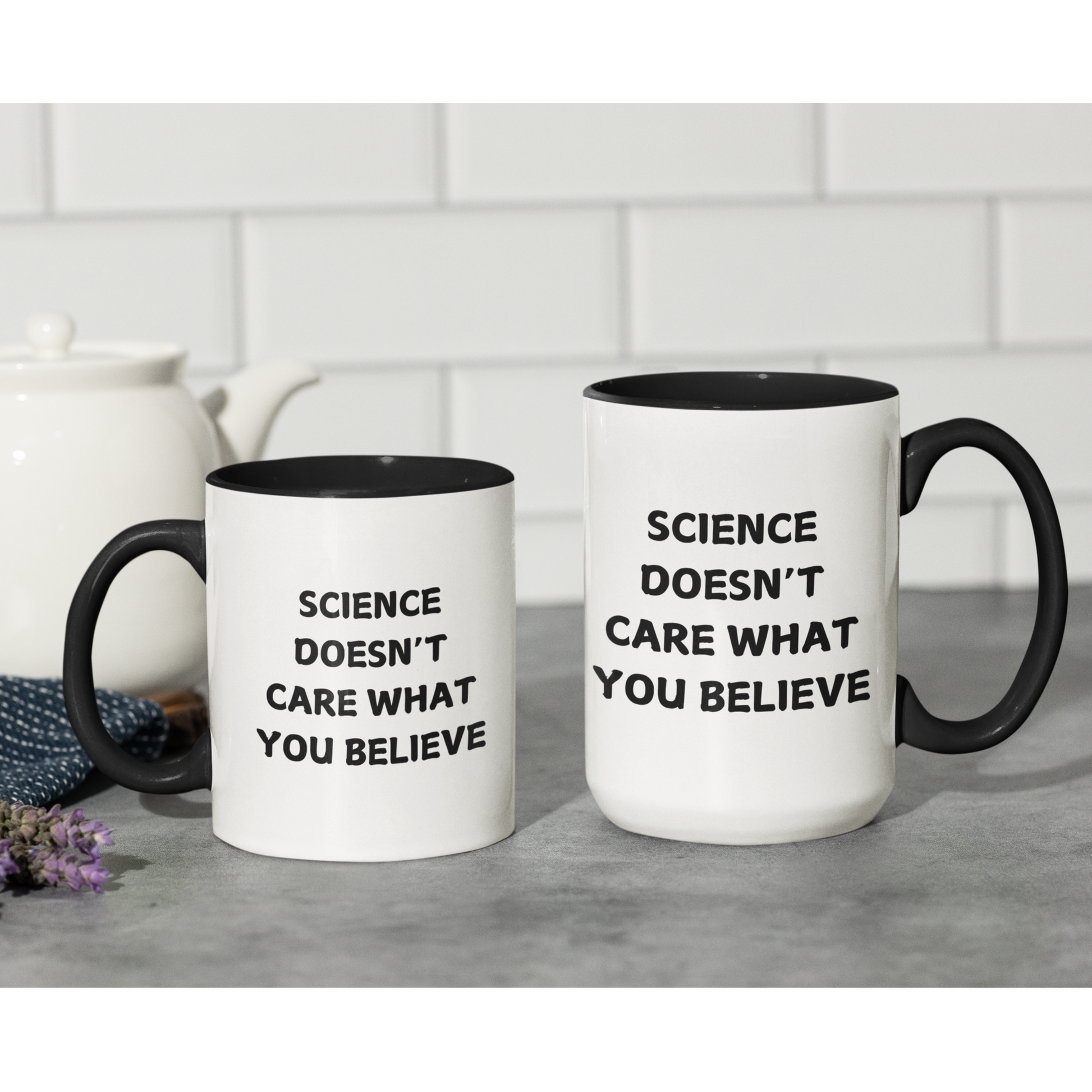 11 & 15 oz stylish ceramic coffee mug with a bold black handle and matching black interior, creating a sleek contrast against its glossy white exterior. The front of the mug features a powerful statement in all-capital black letters: "SCIENCE DOESN'T CARE WHAT YOU BELIEVE." The font is clean and impactful, making the message stand out.