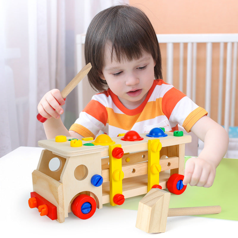 wooden children's tool truck with multicolor plastic screws and plates for assembly with wooden screwdriver. child pictured here playing with this toy