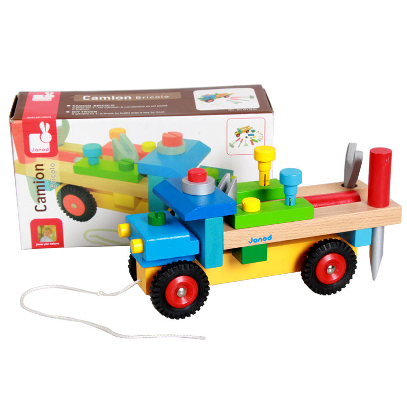 Multicolor wooden truck with tools attached, along with product box behind it