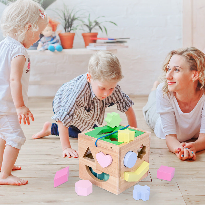 mother and children playing with shape sorting cube