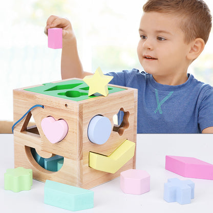 child playing with shape sorting cube