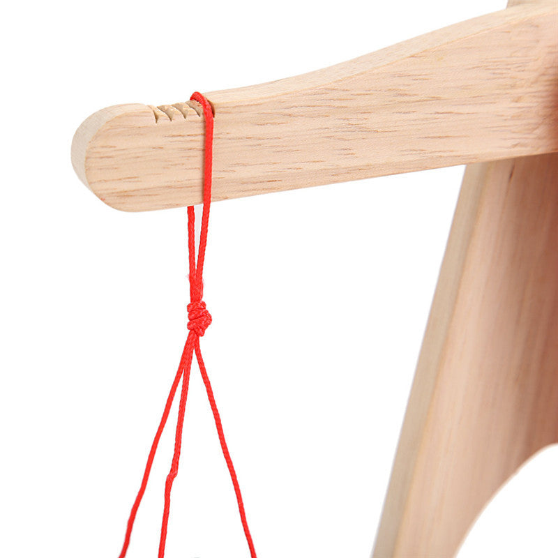 detail of how string hangs on the arm of the balance