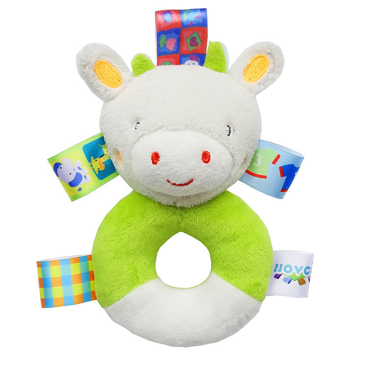 green and white plush cow rattle with circular plush handle for the body and multicolor sensory tags attached