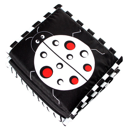 black, white and red crib mount with high contrast images with ladybug on front
