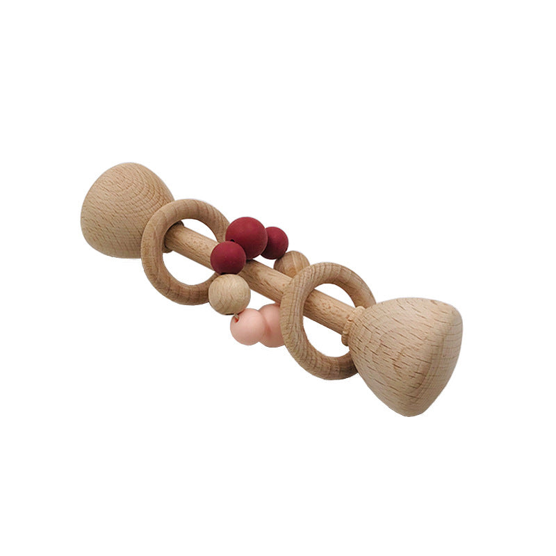 long rattle shaped like barbell with 2 wooden rings on the center handle and one with pink and red  beads
