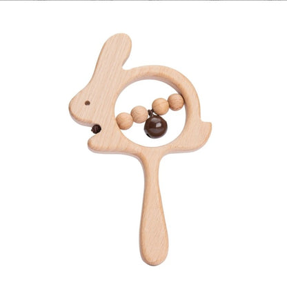 wooden bunny rattle in natural wood with handle with brown bell attached