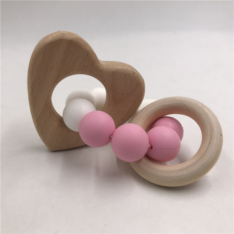natural wood heart teether with pink/white beads
