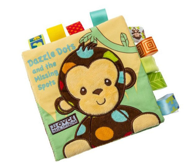 yellow plush book with monkey on front. title of book is "Dazzle Dots and the Missing Spots". Book also has multiple fabric sensory tags attached to the sides