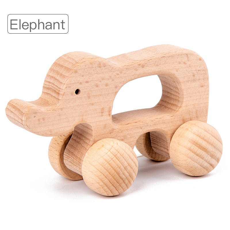 elephant rolling animal toy with natural wood and large round wheels. opening in center of toy for gripping