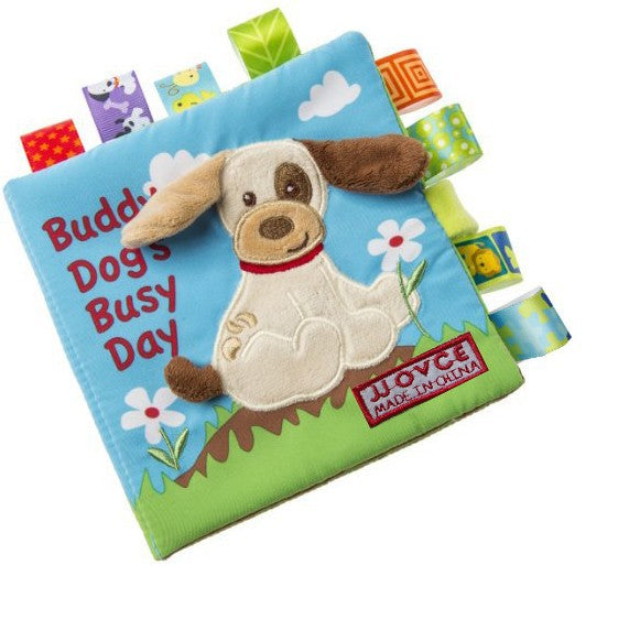 Image of plush book with dog on front called "Buddy Dog's Busy Day". Cover is blue and the book has multiple fabric sensory tags attached