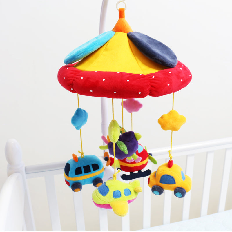 brightly colored plush mobile with plush vehicles hanging