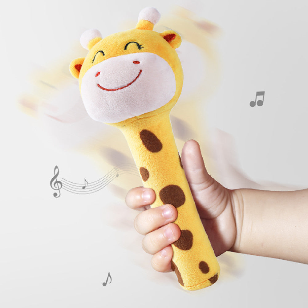 image of child's hand holding plush giraffe stick toy with musical symbols surrounding