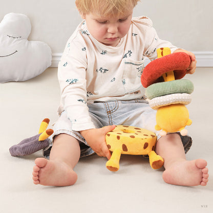 baby playing with giraffe stacking toy