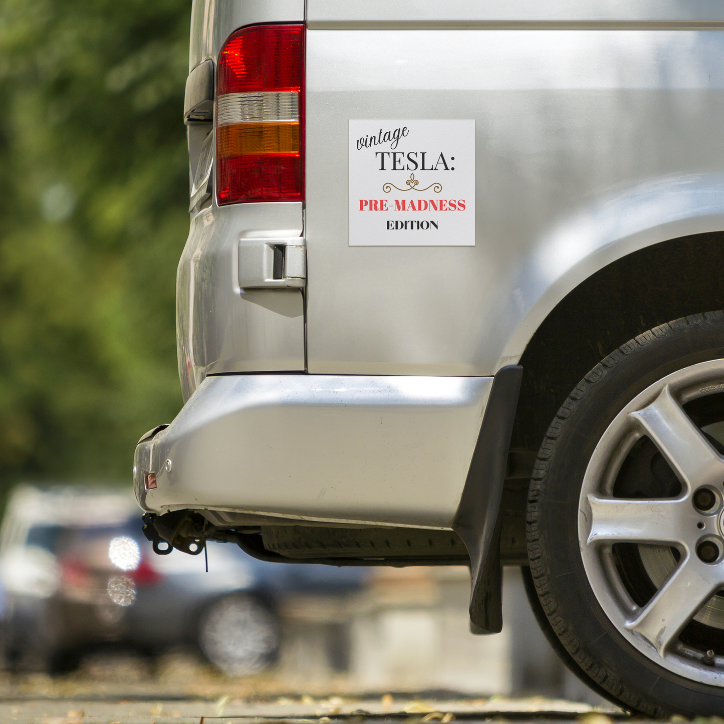 Car magnet design featuring elegant typography with the phrase 'Vintage TESLA: PRE-MADNESS EDITION'. The word 'vintage' is in a stylish cursive black font, 'TESLA:' in bold serif black, and 'PRE-MADNESS' in striking bold red capitals, drawing attention. Below is 'EDITION' in black block letters. A gold ornamental flourish adds a classy vintage touch. Perfect for Tesla enthusiasts who appreciate its legacy before modern chaos!
