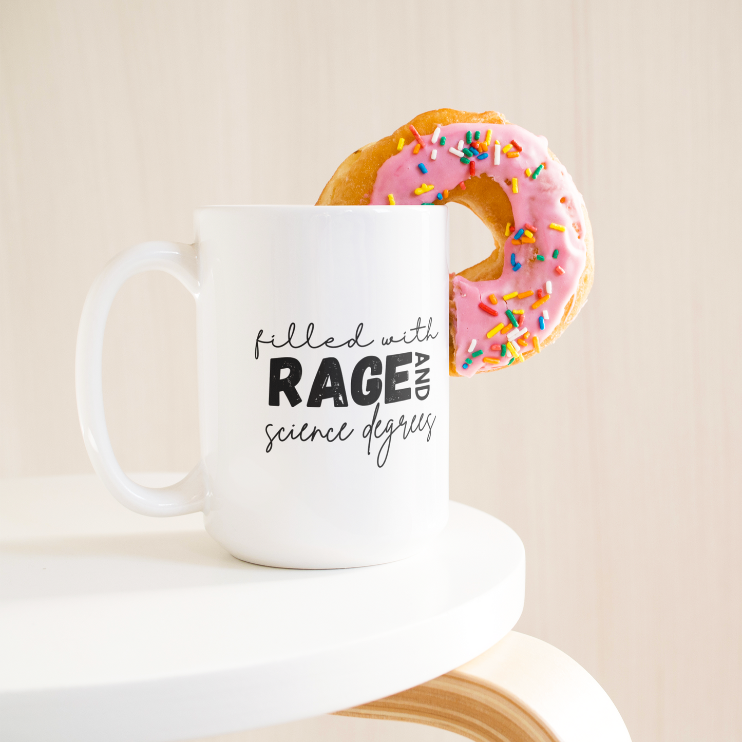 Filled_with_rage_and_science_degrees_mug_15ozWhiteMugLifetsyleDonutLH_Mockup.png