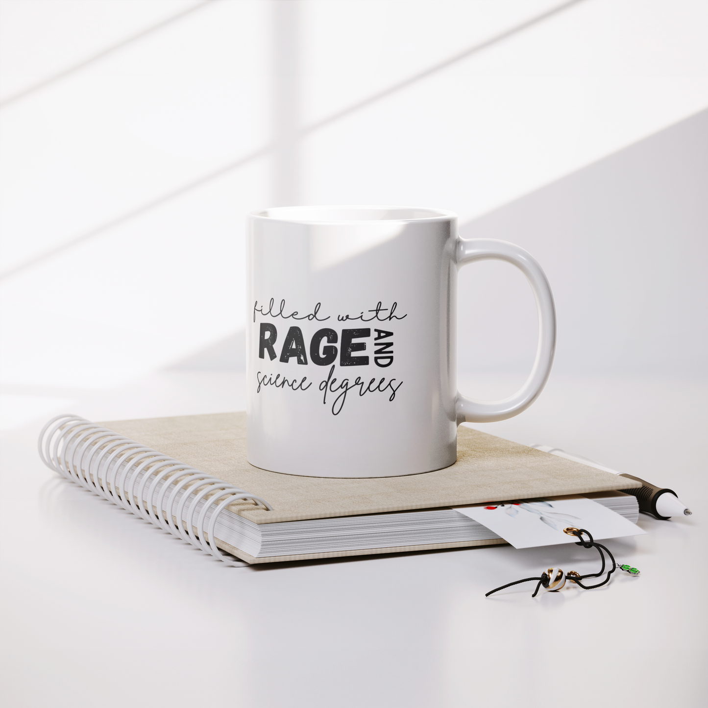 Filled_with_rage_and_science_degrees_mug_Lifestyle_Notebook_Mockup.png