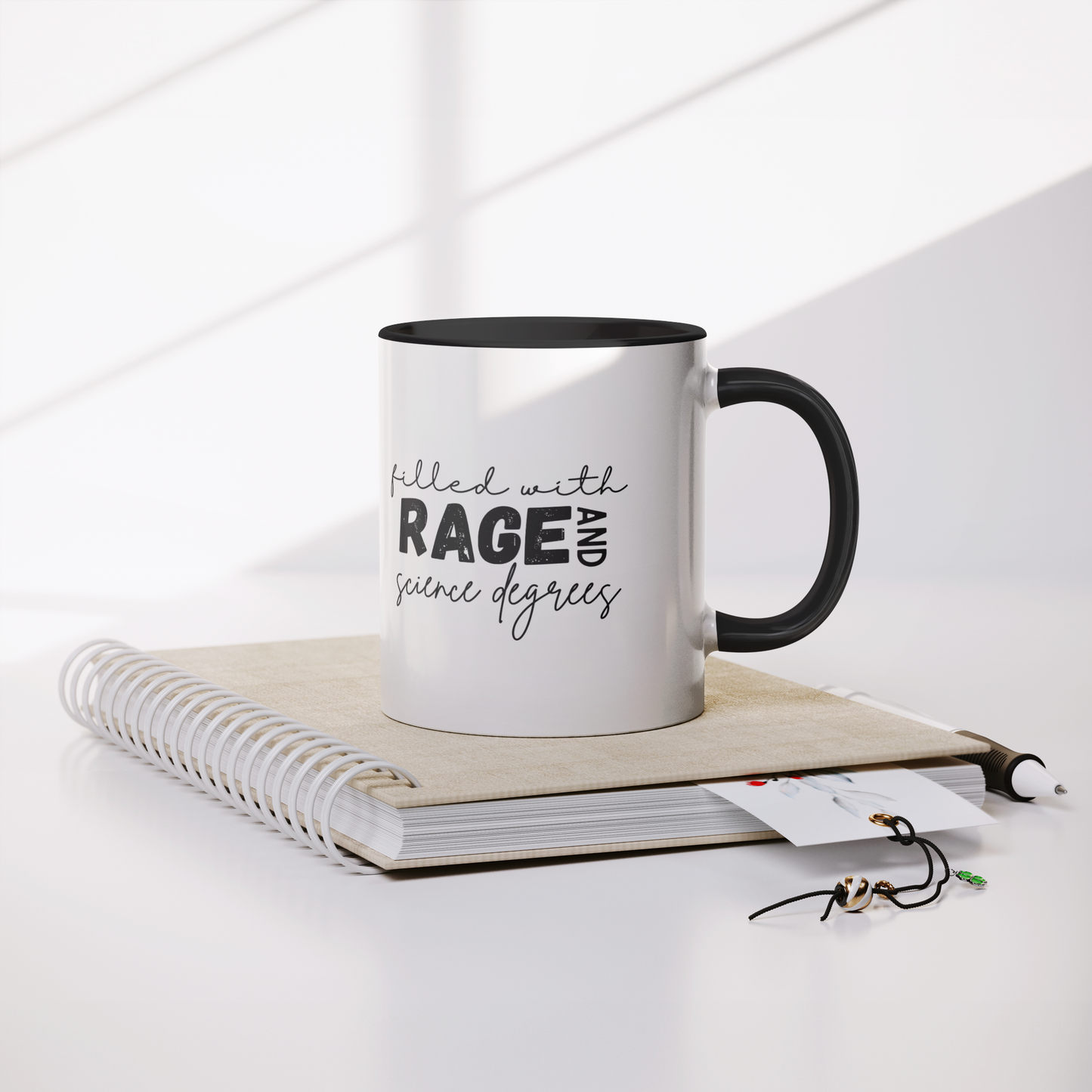 Filled_with_rage_and_science_degrees_mug_Mug_Lifestyle_Notebook_Mockup.png