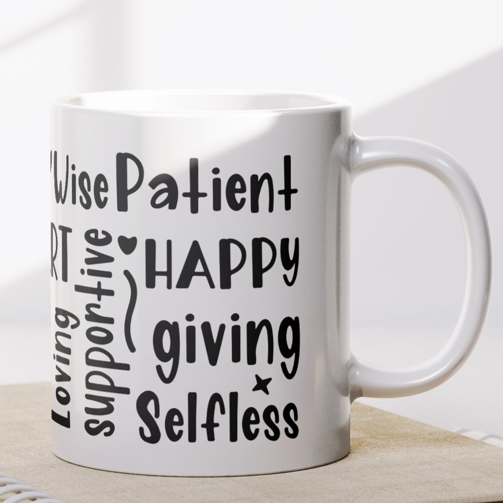 White ceramic coffee mug covered in bold, hand-lettered black typography featuring uplifting words that describe mothers, such as “BRAVE,” “SMART,” “LOVING,” “STRONG,” “HAPPY,” “PATIENT,” and more. The design wraps around the entire mug, creating a vibrant, heartfelt word cloud tribute to mom. Perfect for Mother's Day, birthdays, or just to show appreciation. A thoughtful and inspiring gift for any mom.
