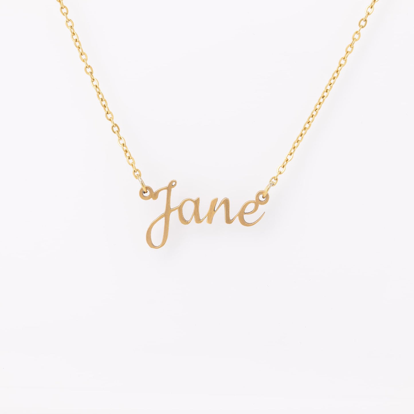 Personalized gold name necklace featuring the name "Jane" in an elegant, cursive font. Crafted from high-quality, polished gold-tone metal, this custom name pendant hangs from a delicate, durable chain with secure link attachments. Displayed against a clean, white background to highlight its timeless and minimalist design. Ideal as a thoughtful, customized gift for birthdays, anniversaries, or special occasions, adding a personal touch to any jewelry collection.