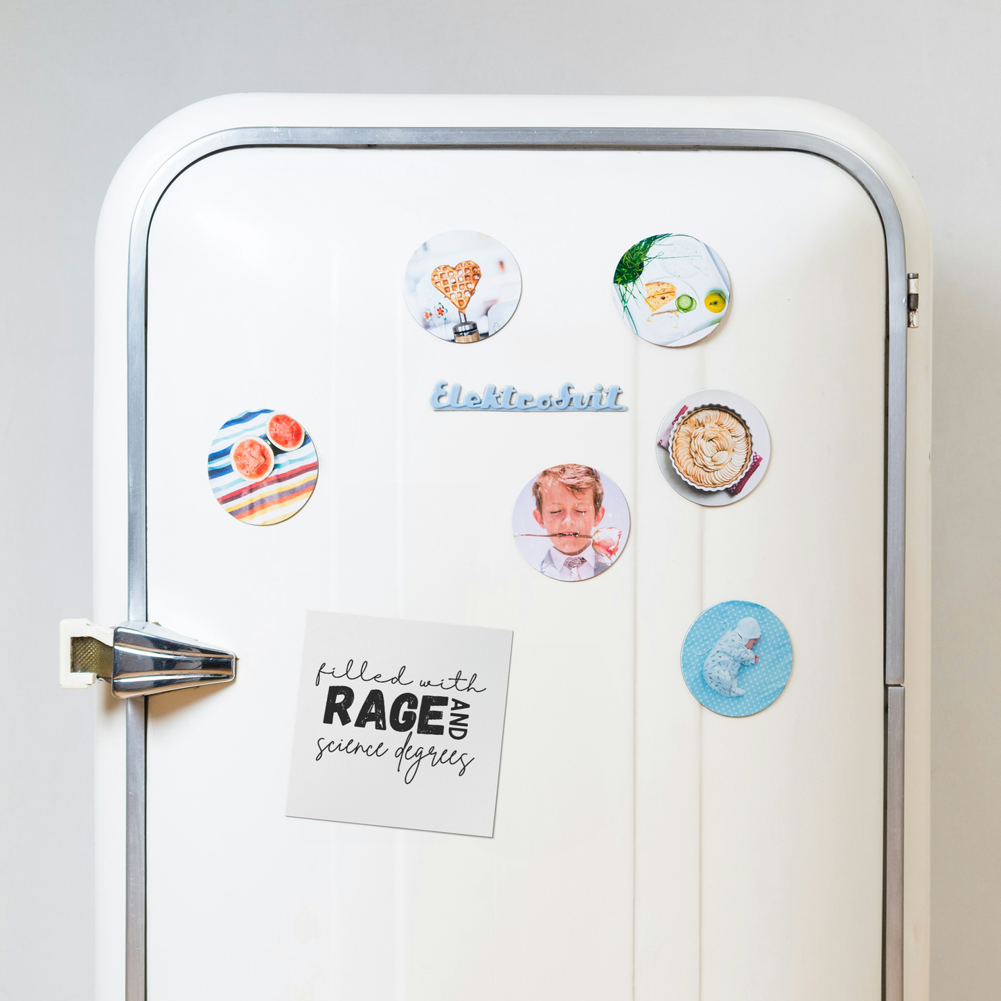 A white square magnet with a bold, empowering message: “filled with RAGE AND science degrees.” The word “RAGE” stands out in large, distressed block letters, while the rest of the text uses elegant, cursive script for contrast. “AND” is rotated vertically next to “RAGE.” Perfect for scientists, students, or professionals who combine intellect with passion. Adds a fierce, witty touch to any fridge, office, or lab space.