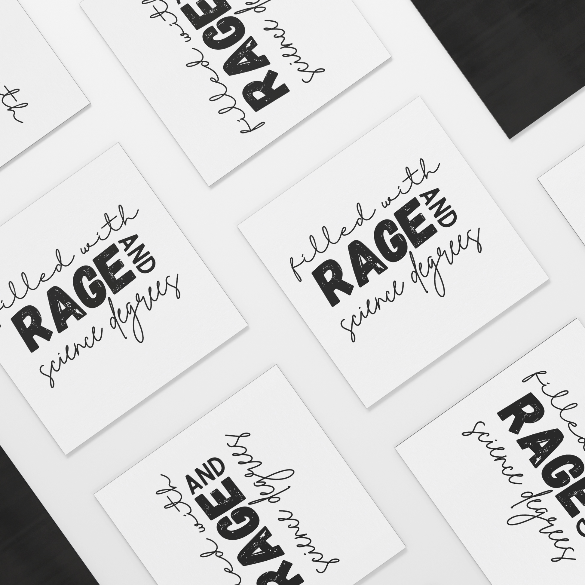 A white square magnet with a bold, empowering message: “filled with RAGE AND science degrees.” The word “RAGE” stands out in large, distressed block letters, while the rest of the text uses elegant, cursive script for contrast. “AND” is rotated vertically next to “RAGE.” Perfect for scientists, students, or professionals who combine intellect with passion. Adds a fierce, witty touch to any fridge, office, or lab space.