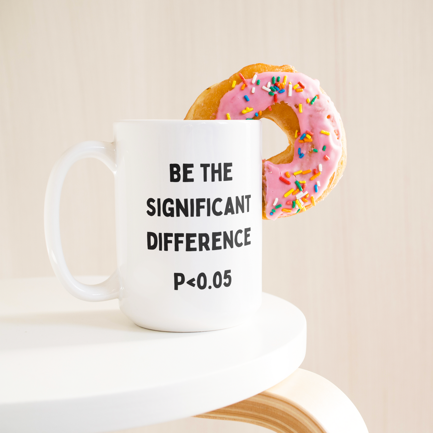 Statisticians_Cup__Be_The_Significant__15ozWhiteMugLifetsyleDonutLH_Mockup.png