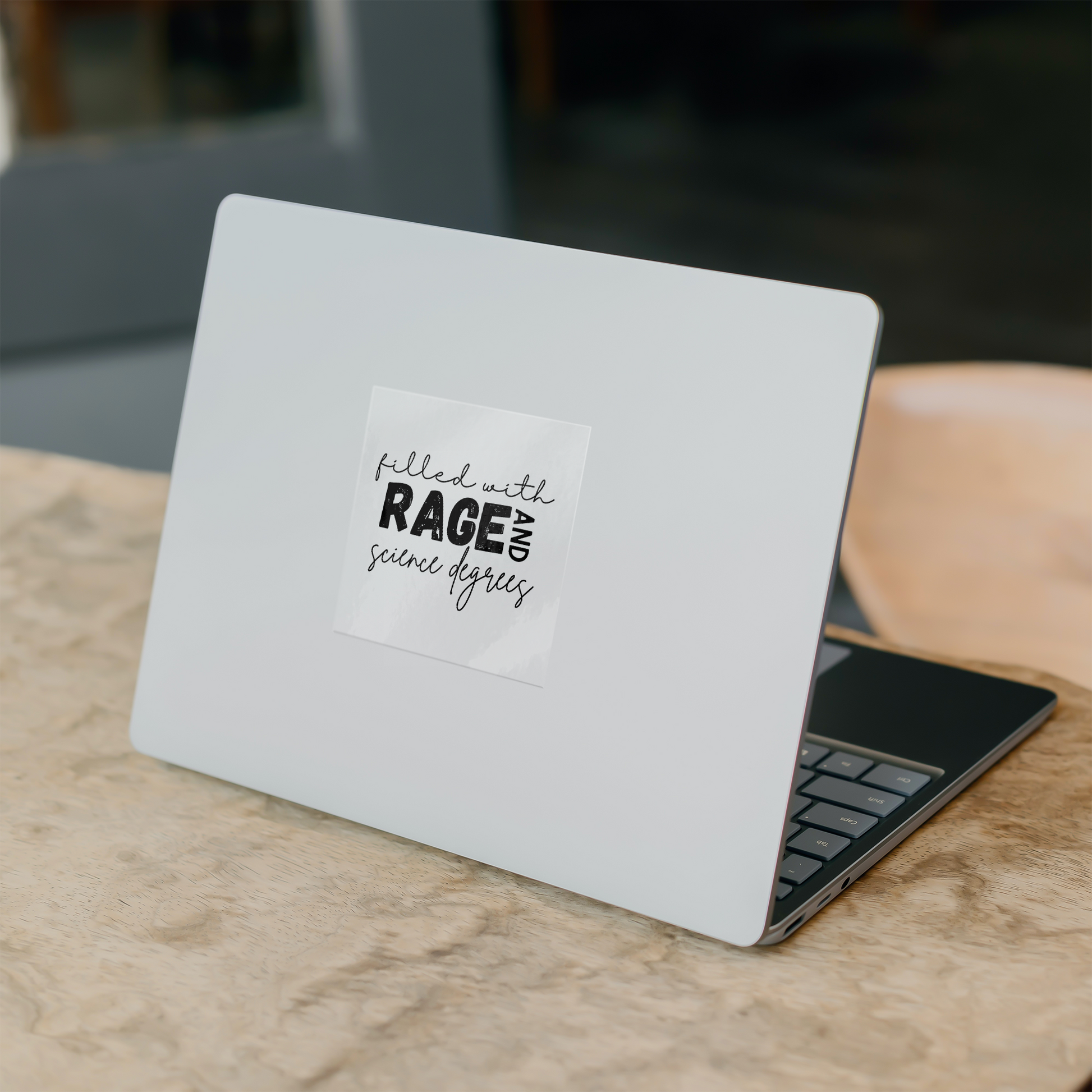 Sticker design featuring a bold, empowering quote: “Filled with RAGE and science degrees.” The word “RAGE” is in all caps, distressed block letters for a dramatic, rebellious feel, while the rest of the phrase is in an elegant, handwritten script that contrasts with the boldness. Perfect for laptops, water bottles, or notebooks—ideal for scientists, students, feminists, and activists who embrace both intellect and passion. Matte finish, durable vinyl.