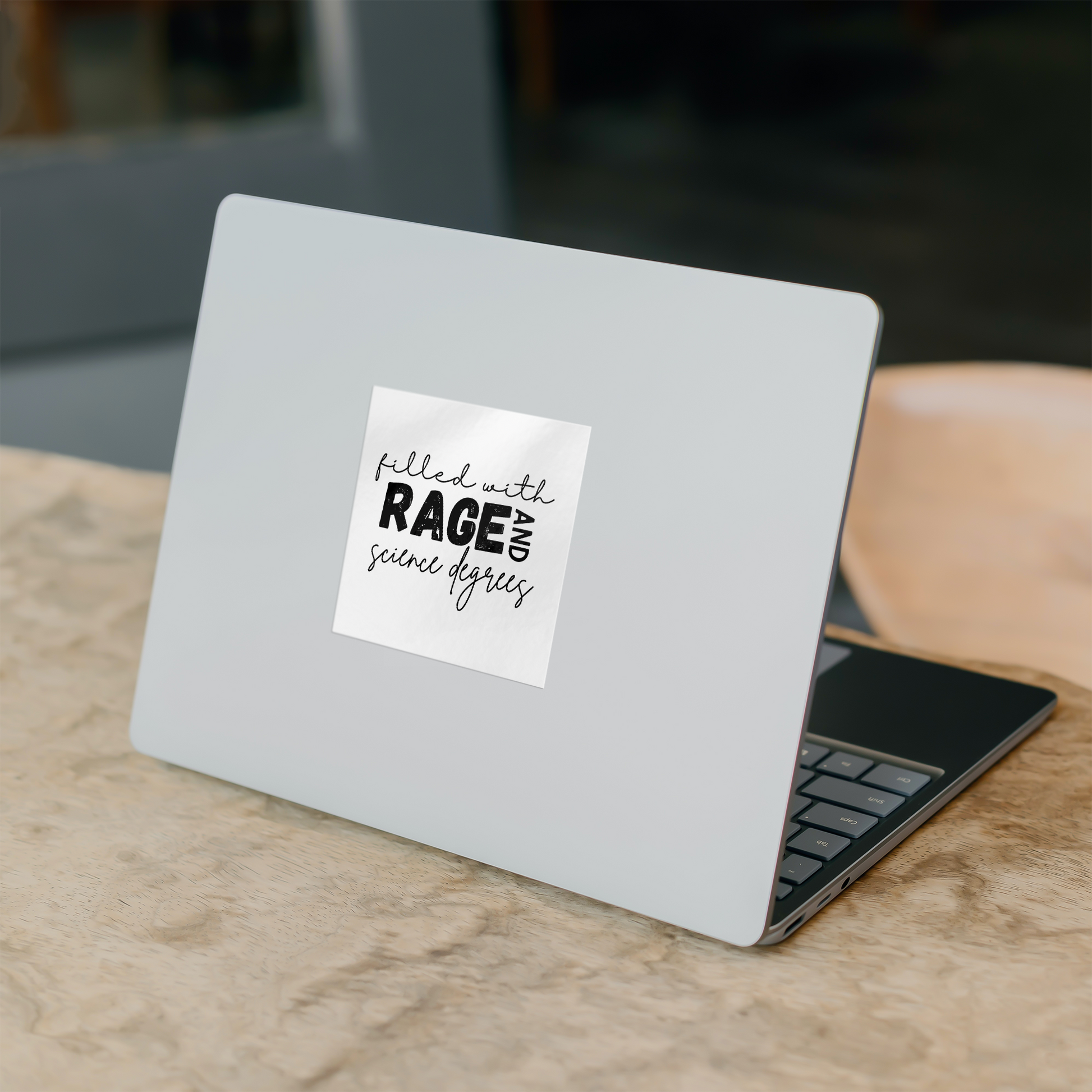 Sticker design featuring a bold, empowering quote: “Filled with RAGE and science degrees.” The word “RAGE” is in all caps, distressed block letters for a dramatic, rebellious feel, while the rest of the phrase is in an elegant, handwritten script that contrasts with the boldness. Perfect for laptops, water bottles, or notebooks—ideal for scientists, students, feminists, and activists who embrace both intellect and passion. Matte finish, durable vinyl.