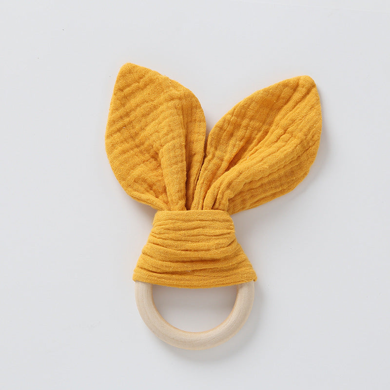 orange muslin bunny ears on natural wood ring