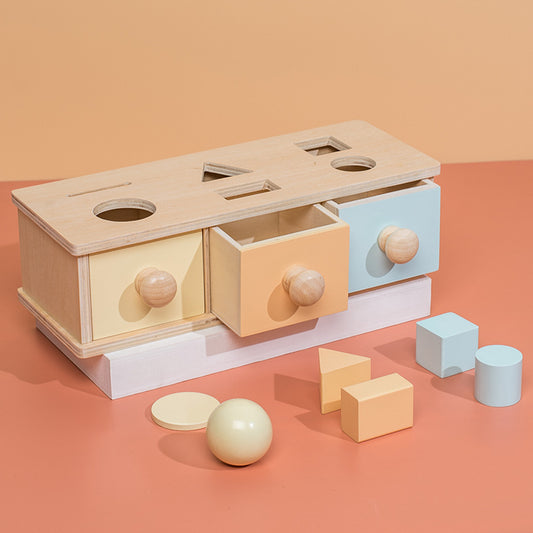 object permanence wooden box with drawers and shape sorter slots on the top
