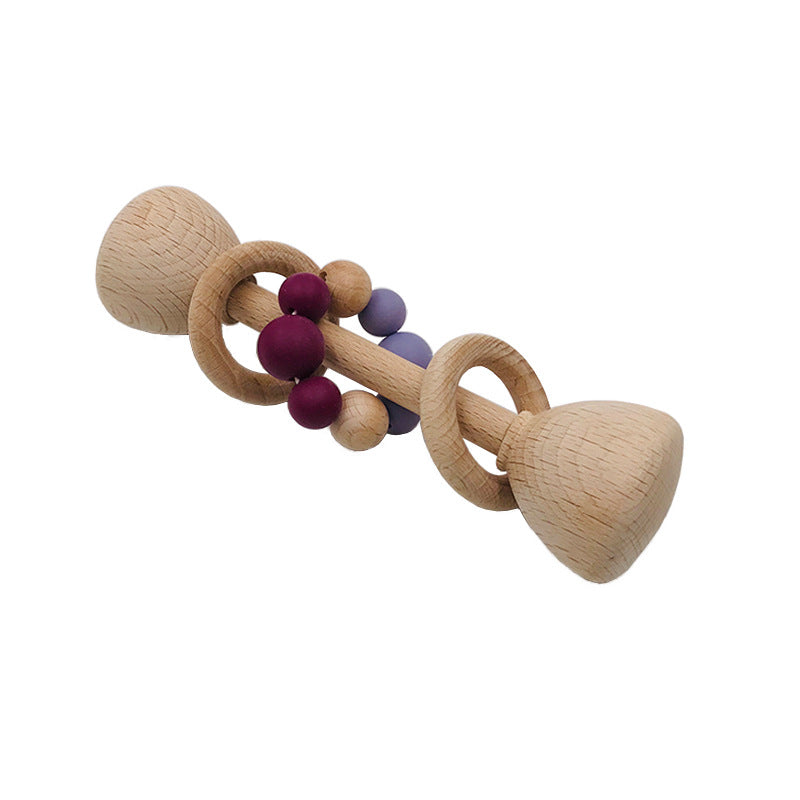 long rattle shaped like barbell with 2 wooden rings on the center handle and one with maroon and purple  beads